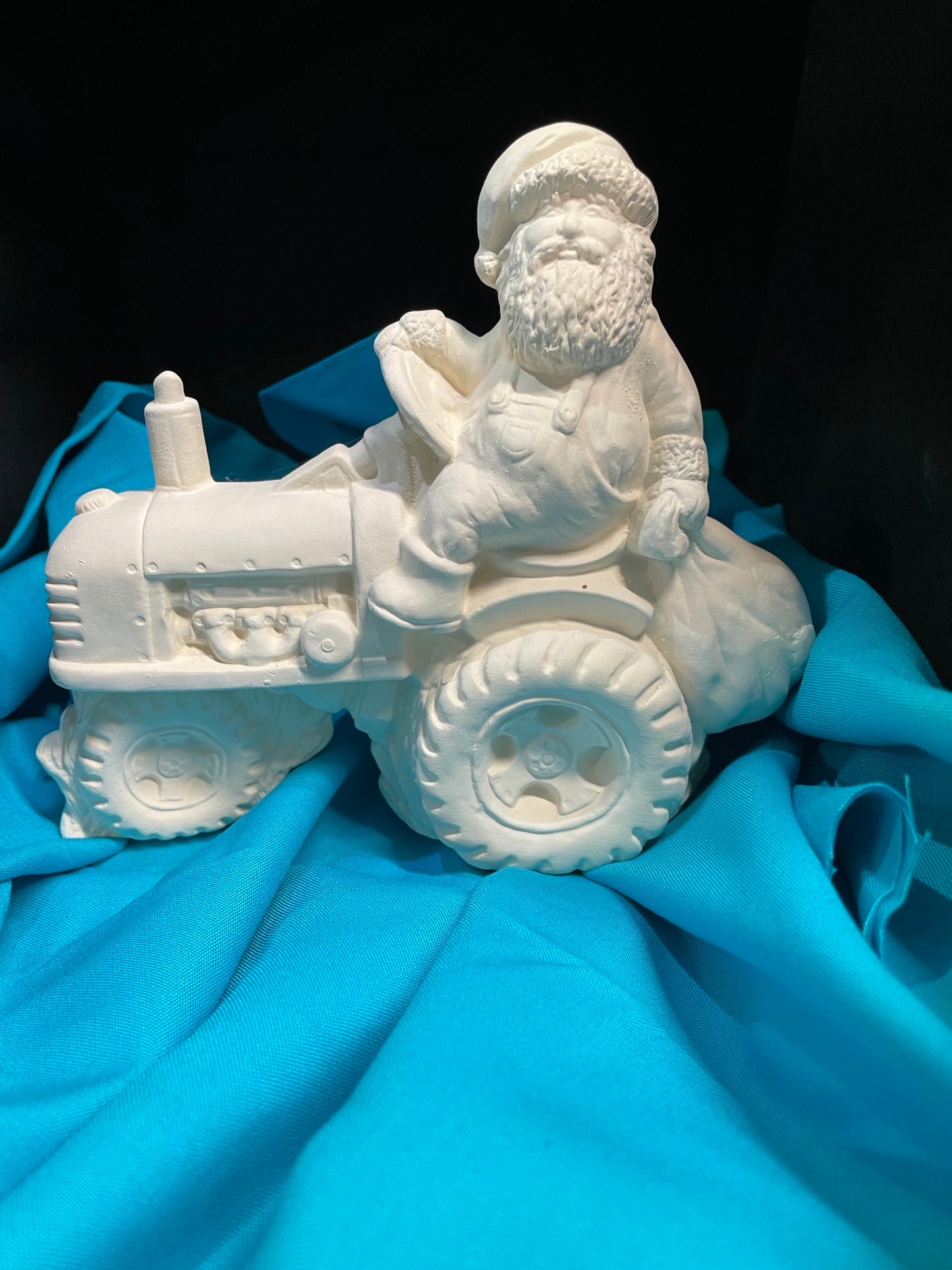 Santa Riding a Tractor Ceramic Bisque